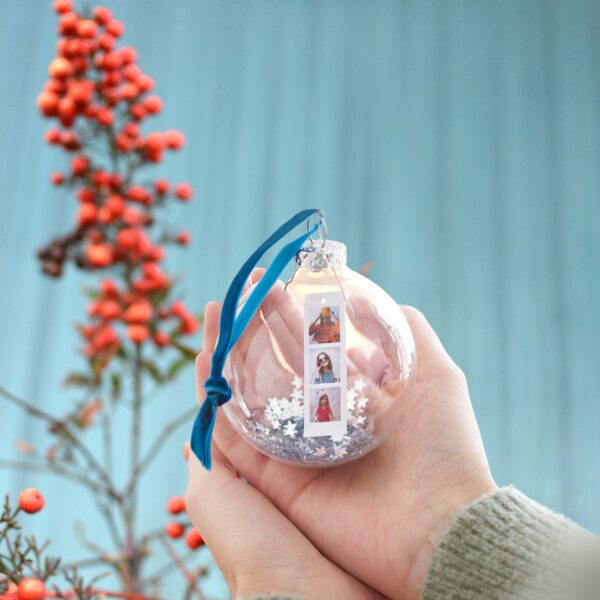 Glass bauble with photos displayed inside and silver star sequins